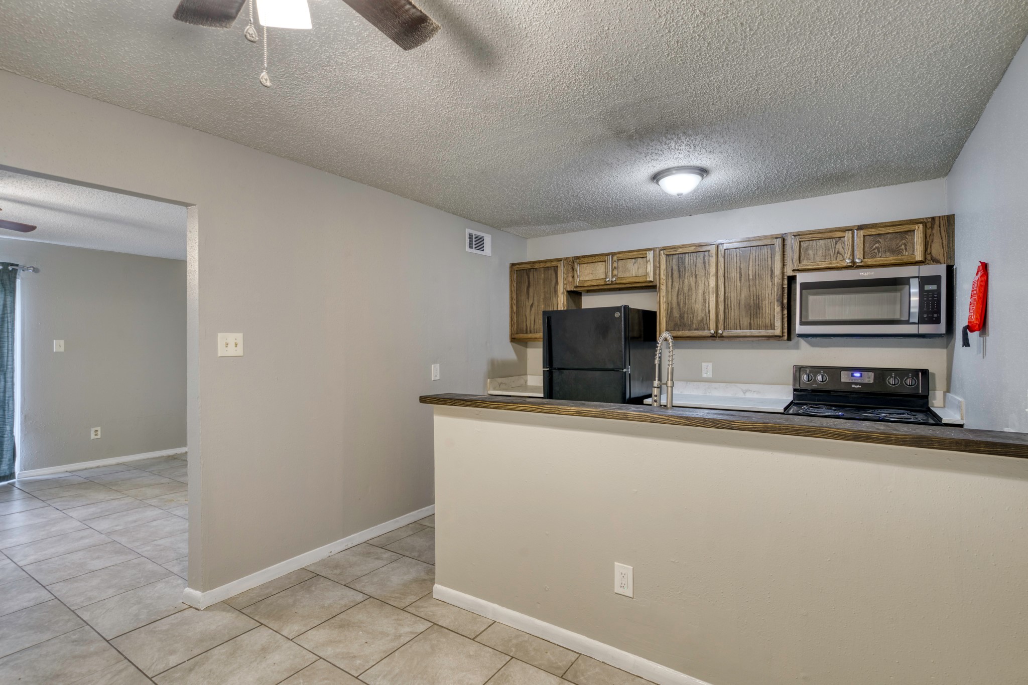 2000 Kazmeier Plaza Bryan, TX 77802 - Photo 16 of 23 a kitchen with stainless steel appliances a refrigerator a stove a sink a microwave and island