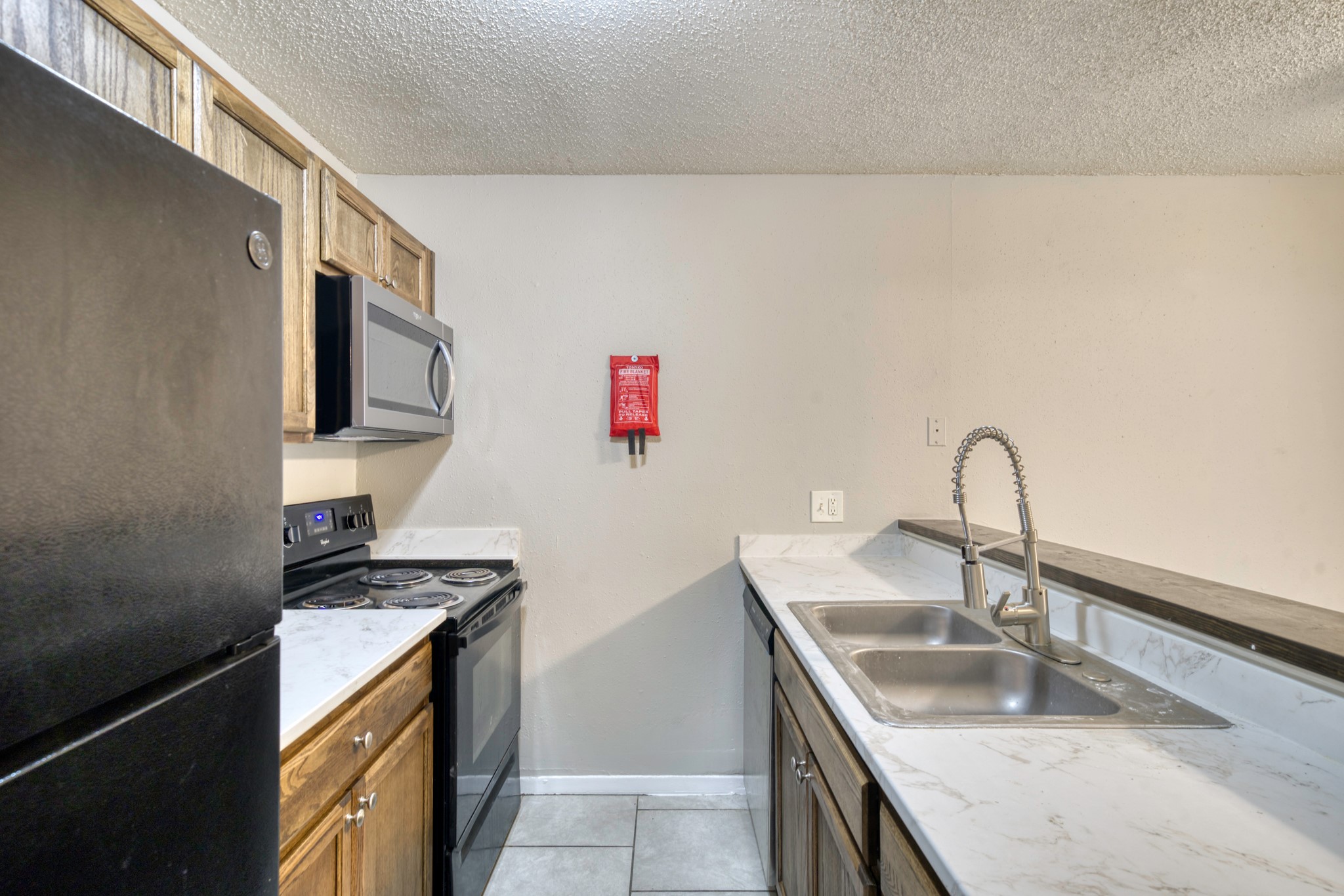 2000 Kazmeier Plaza Bryan, TX 77802 - Photo 17 of 23 a kitchen with a sink and a stove top oven