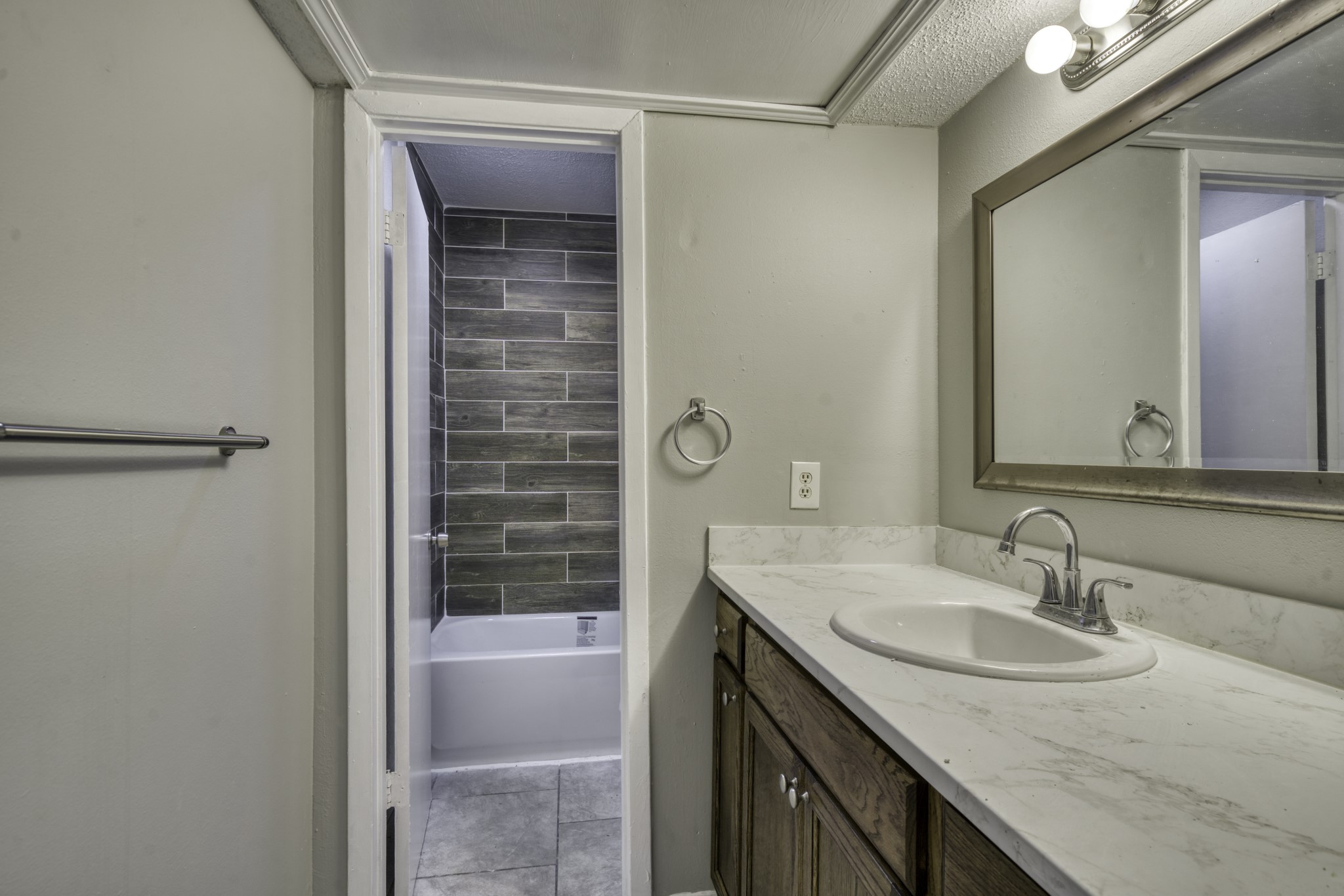 2000 Kazmeier Plaza Bryan, TX 77802 - Photo 21 of 23 a bathroom with a granite countertop sink and a mirror