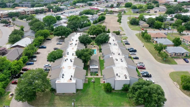 an aerial view of multiple houses with yard