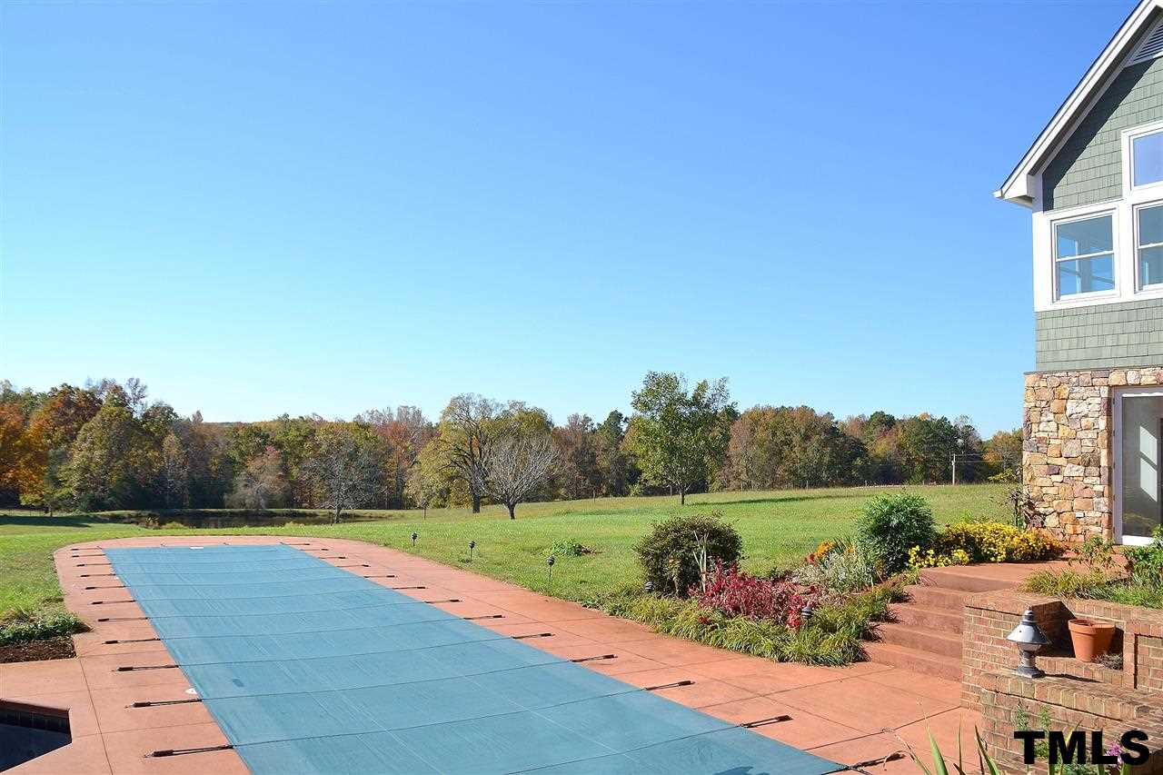 7411 Bill Poole Road Rougemont, NC 27572 - Photo 20 of 25 It's Easy to Bring the Living Outdoors when a Lap Pool, Hot Tub & Picturesque View Await!