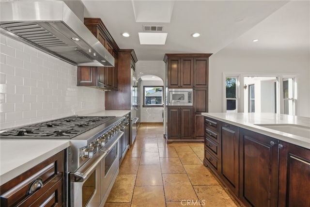 a kitchen with stainless steel appliances a refrigerator and a sink