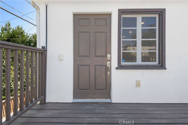 a living room with furniture and view of kitchen