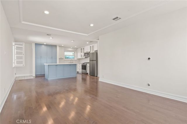 a kitchen with a refrigerator a stove a sink and a microwave