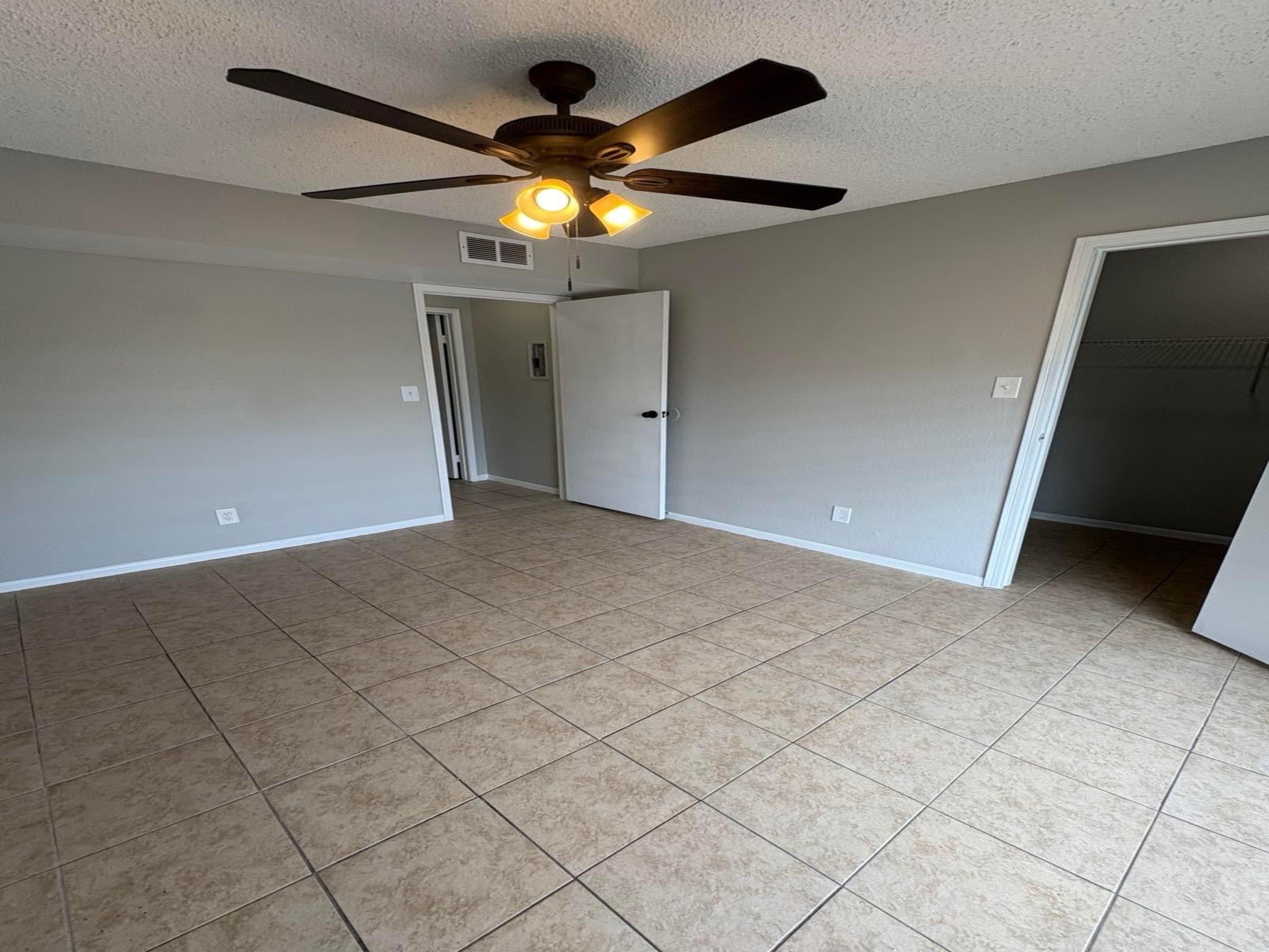 10101 South Gessner Road, Unit 515 Houston, TX 77071 - Photo 5 of 10 a view of an empty room with a chandelier fan