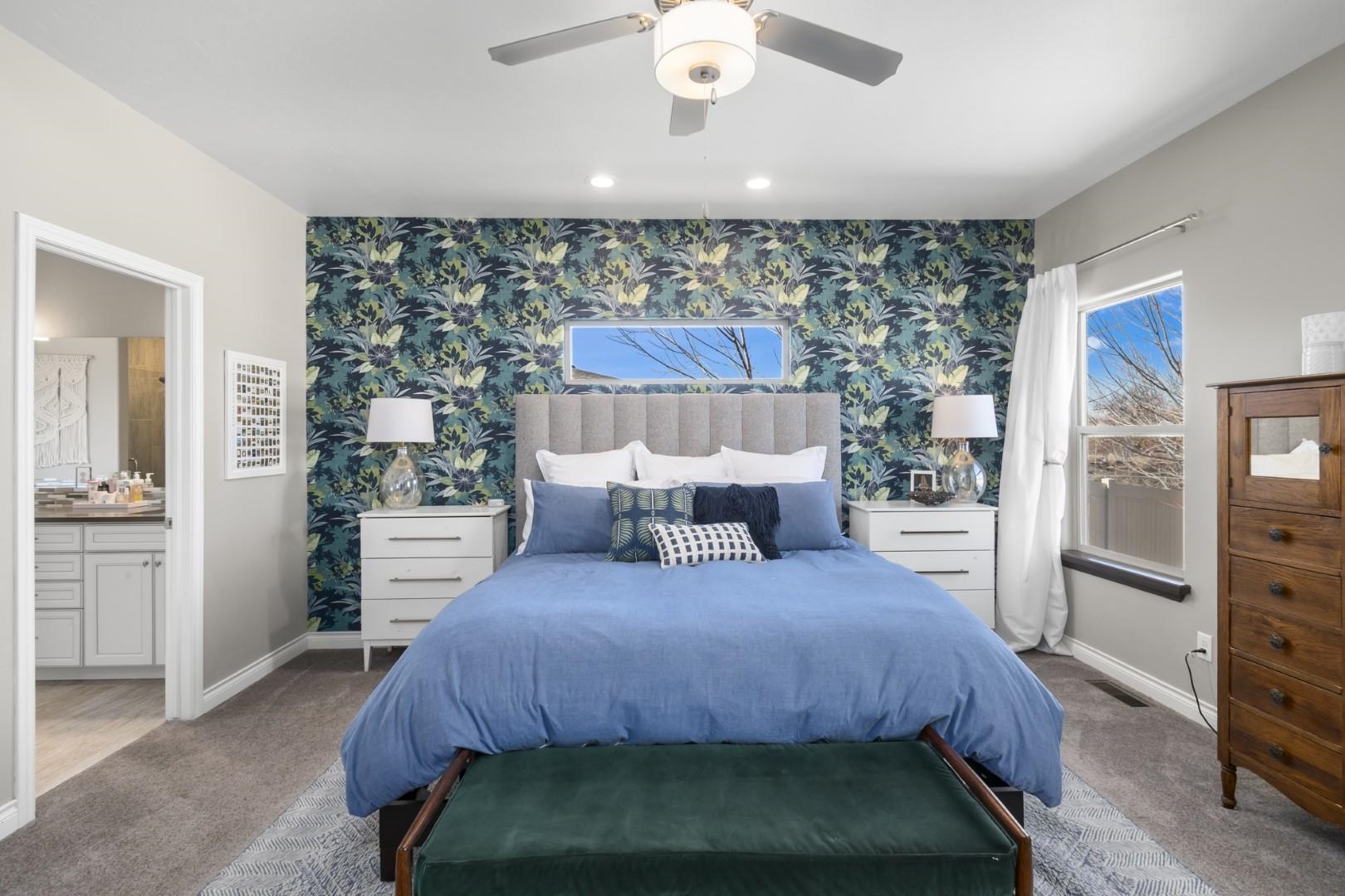 744 Ruby Ranch Drive Grand Junction, CO 81505 - Photo 11 of 33 a bedroom with a bed a mirror and a large window