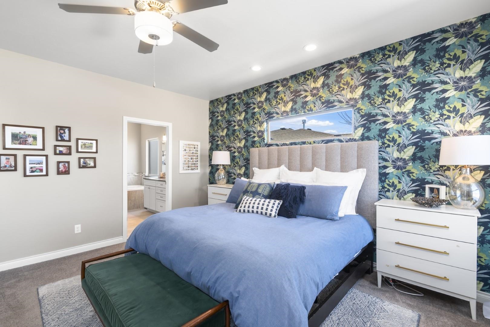 744 Ruby Ranch Drive Grand Junction, CO 81505 - Photo 14 of 33 a bedroom with a large bed and a chandelier