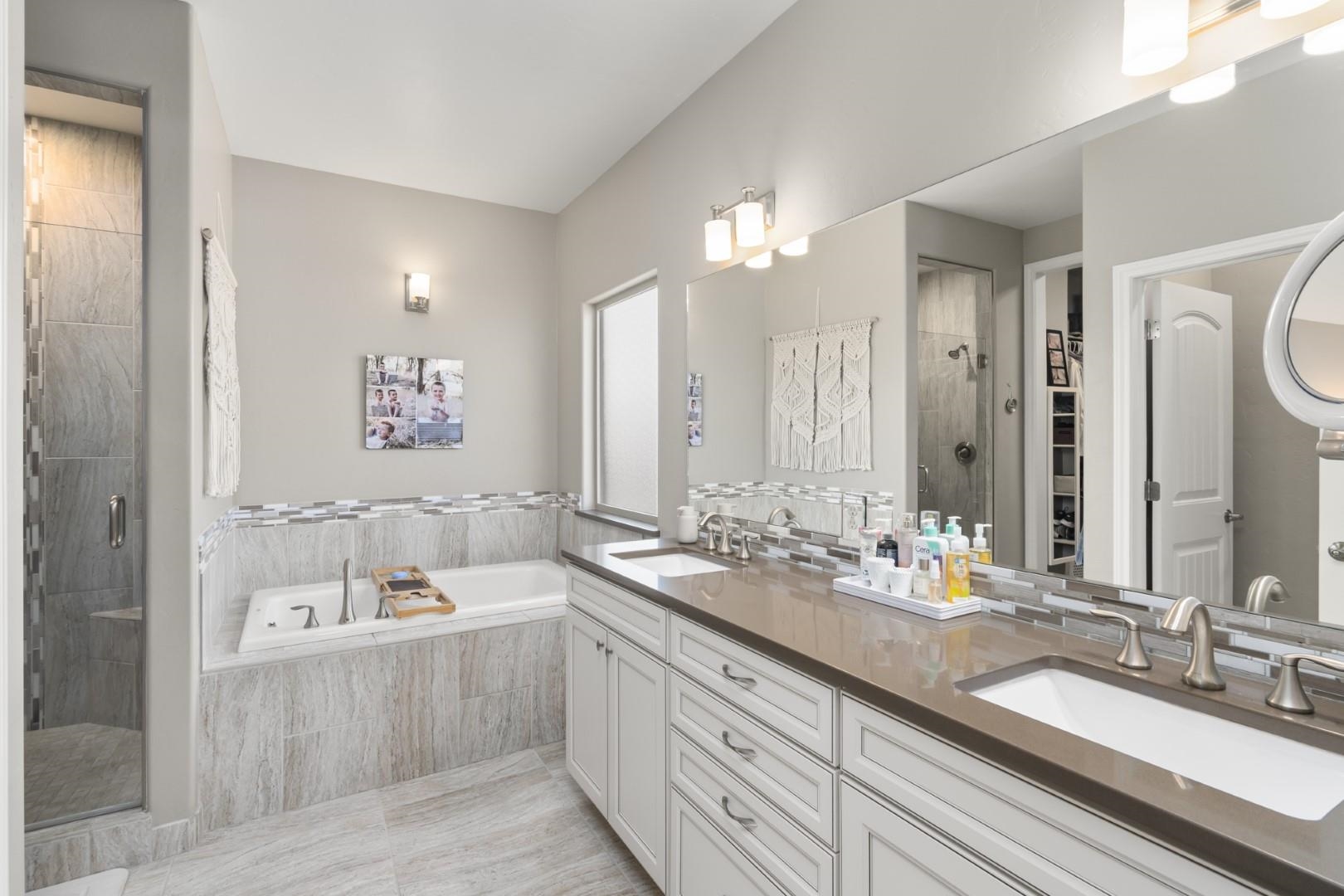 744 Ruby Ranch Drive Grand Junction, CO 81505 - Photo 15 of 33 a bathroom with 2 sink tub and a mirror