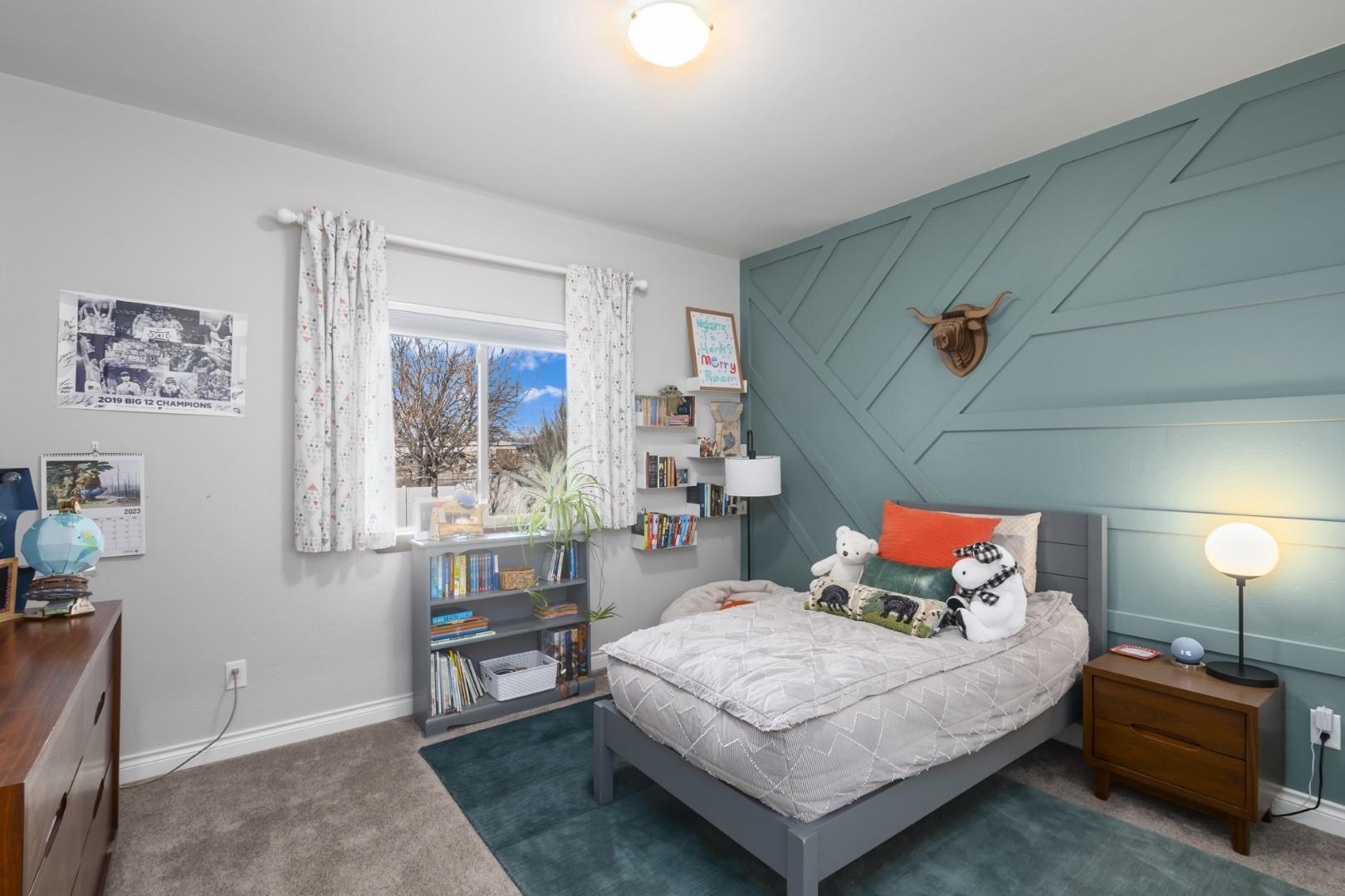 744 Ruby Ranch Drive Grand Junction, CO 81505 - Photo 18 of 33 a bedroom with a bed a window and dresser