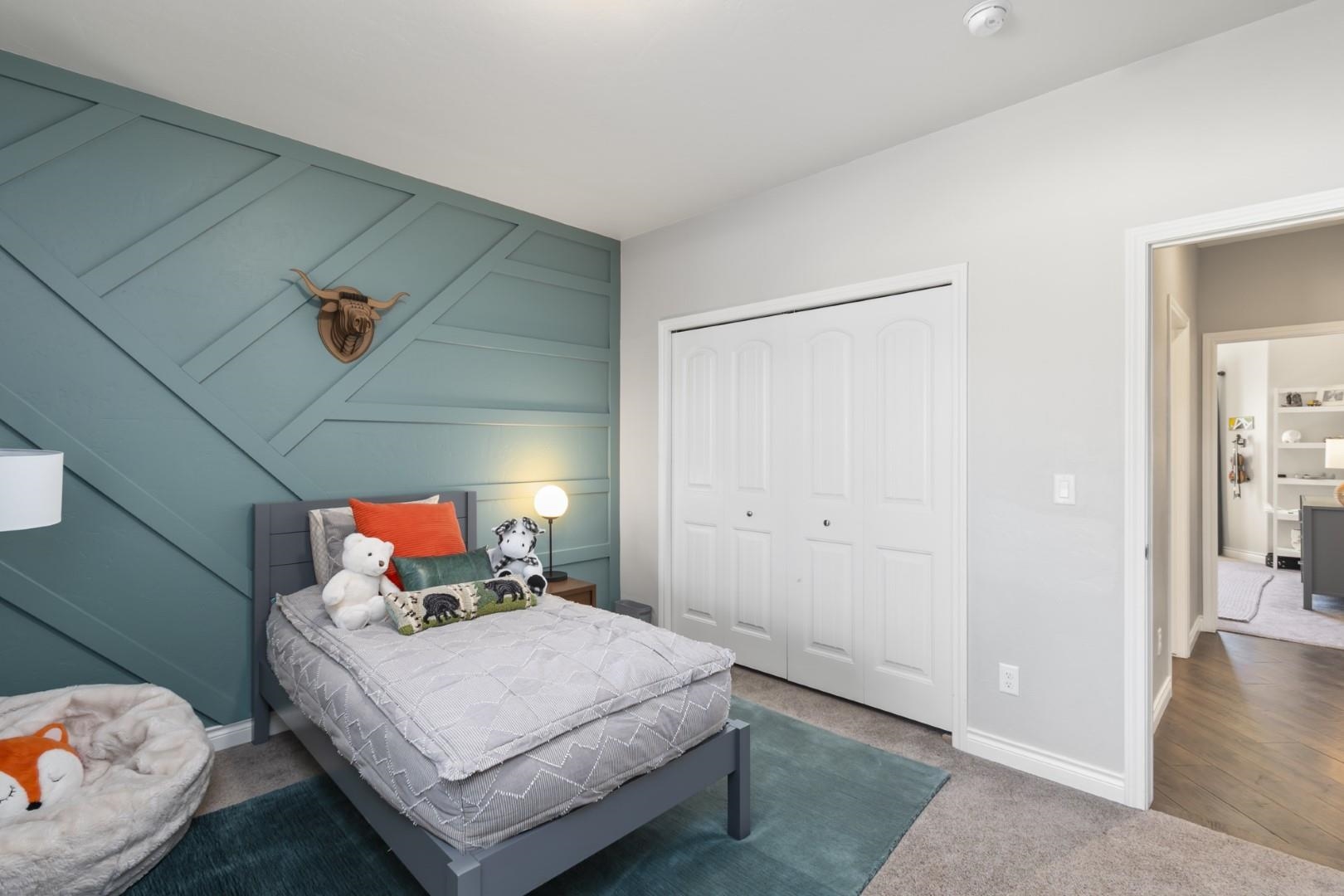 744 Ruby Ranch Drive Grand Junction, CO 81505 - Photo 19 of 33 a bedroom with a bed and wooden floor