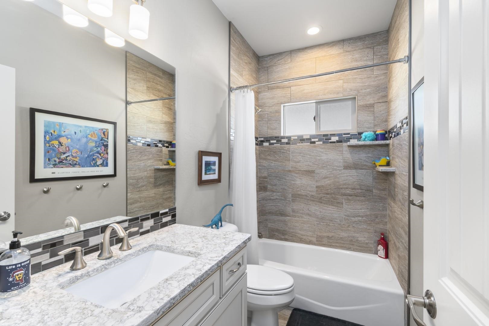 744 Ruby Ranch Drive Grand Junction, CO 81505 - Photo 20 of 33 a bathroom with a granite countertop sink toilet and shower