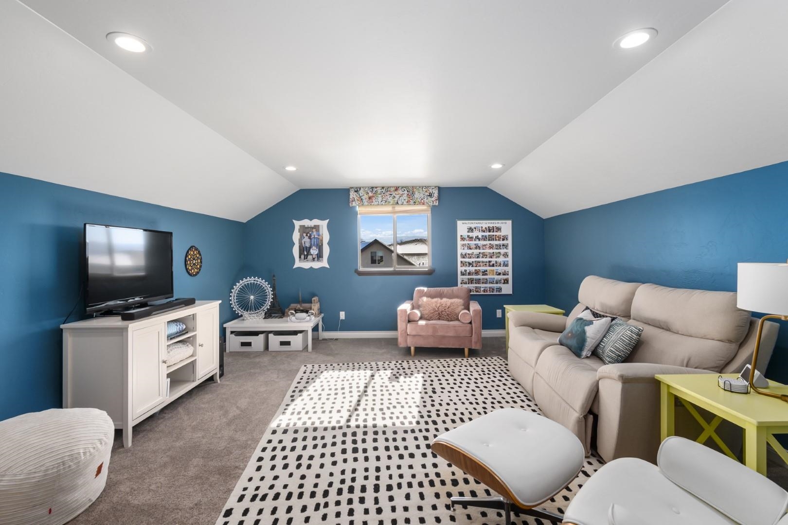 744 Ruby Ranch Drive Grand Junction, CO 81505 - Photo 25 of 33 a living room with furniture and a flat screen tv