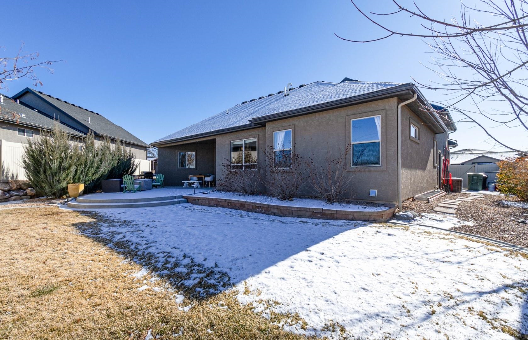 744 Ruby Ranch Drive Grand Junction, CO 81505 - Photo 28 of 33 a backyard of a house with yard and outdoor seating