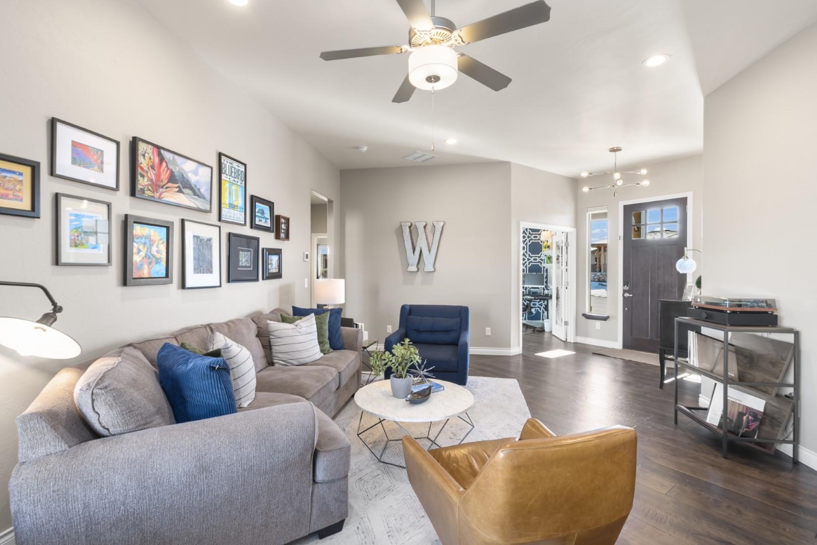 744 Ruby Ranch Drive Grand Junction, CO 81505 - Photo 3 of 33 a living room with furniture kitchen view and a wooden floor