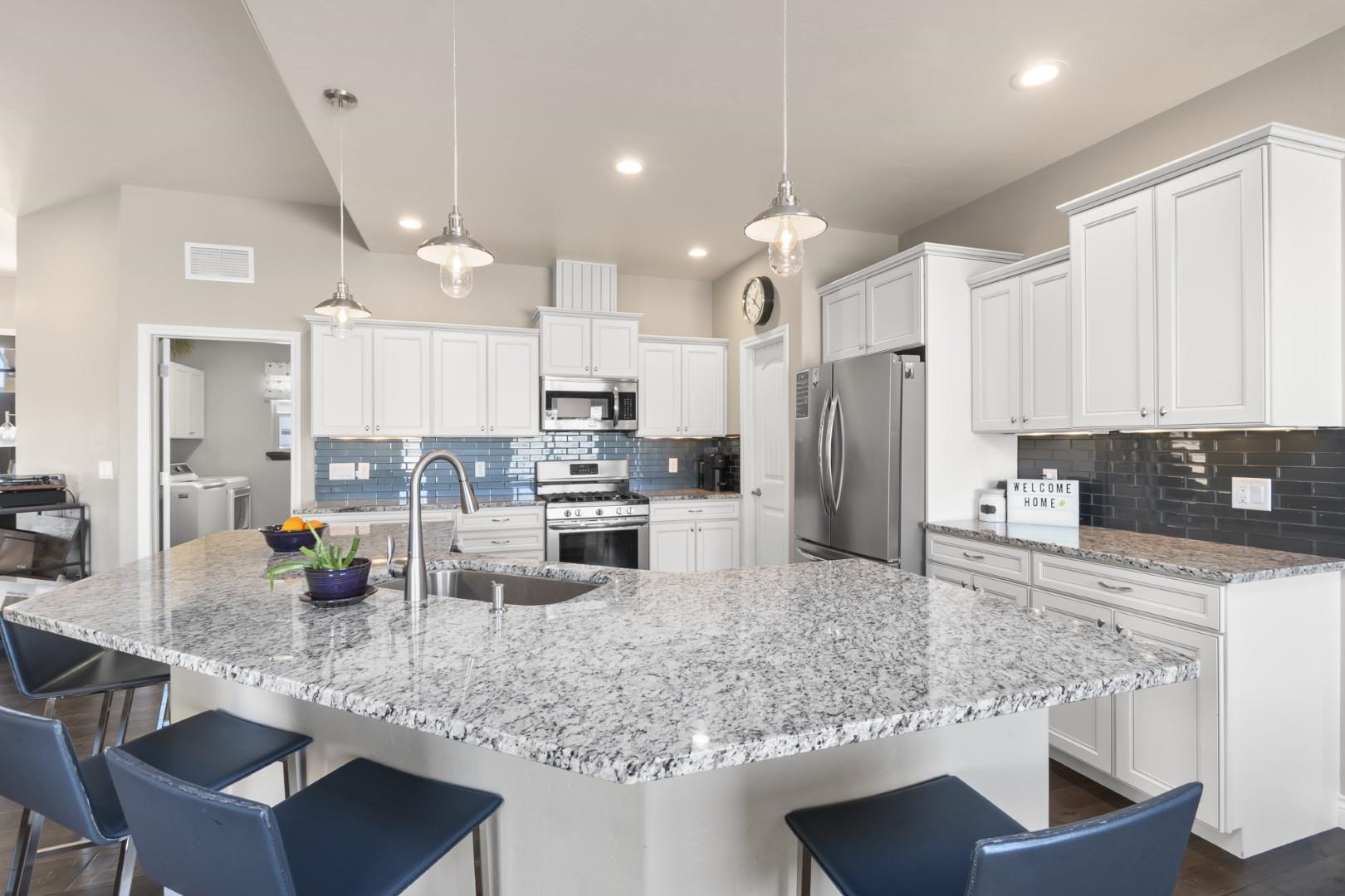 744 Ruby Ranch Drive Grand Junction, CO 81505 - Photo 6 of 33 a kitchen with stainless steel appliances granite countertop a sink refrigerator and cabinets
