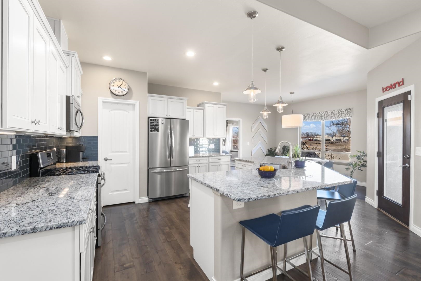 744 Ruby Ranch Drive Grand Junction, CO 81505 - Photo 7 of 33 a kitchen with stainless steel appliances granite countertop a refrigerator a sink a stove a dining table and chairs