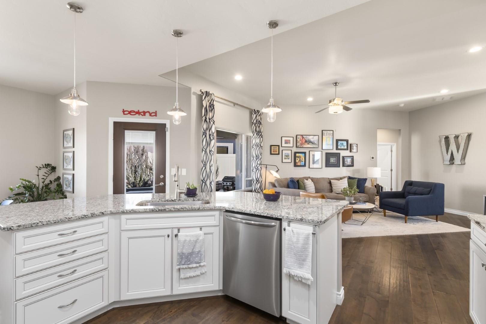 744 Ruby Ranch Drive Grand Junction, CO 81505 - Photo 9 of 33 a kitchen with stainless steel appliances kitchen island granite countertop a sink cabinets and wooden floor
