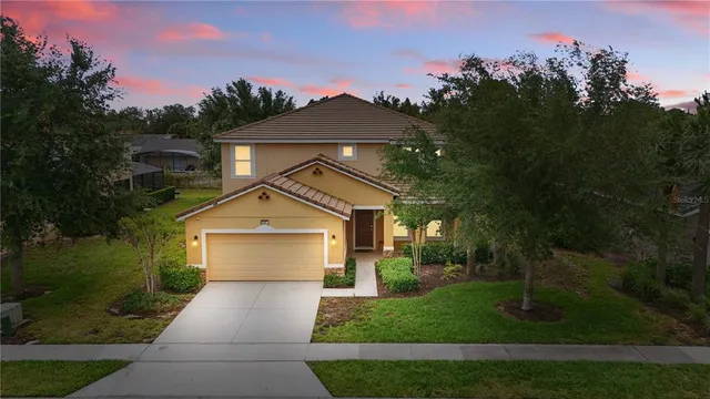 a front view of a house with a yard and garage