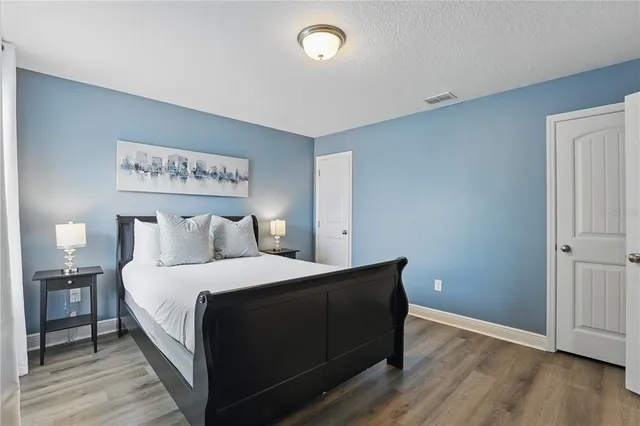 a bedroom with a bed and a night stand