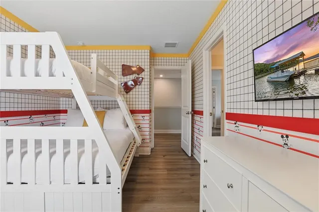 a view of a swimming pool with a patio and a backyard