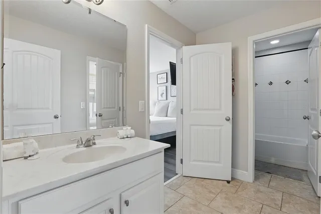 a view of a swimming pool with a patio and a yard