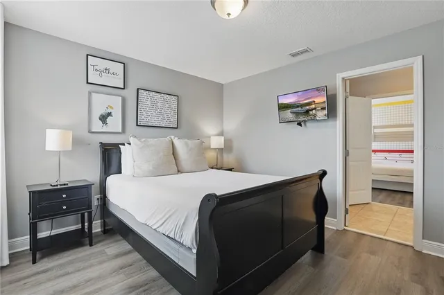 a view of a swimming pool with a patio and a yard