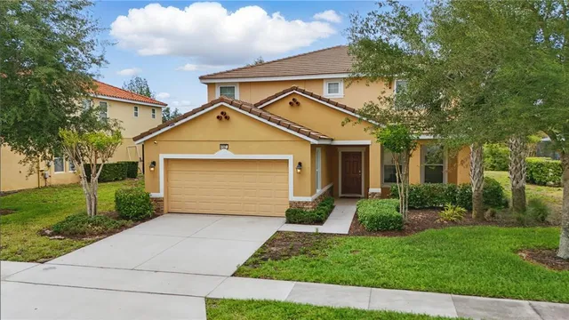a living room with furniture and a dining table with kitchen view