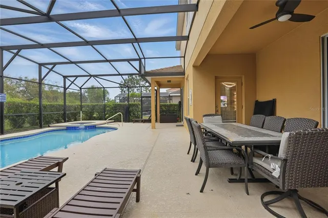 an aerial view of residential houses with outdoor space and swimming pool