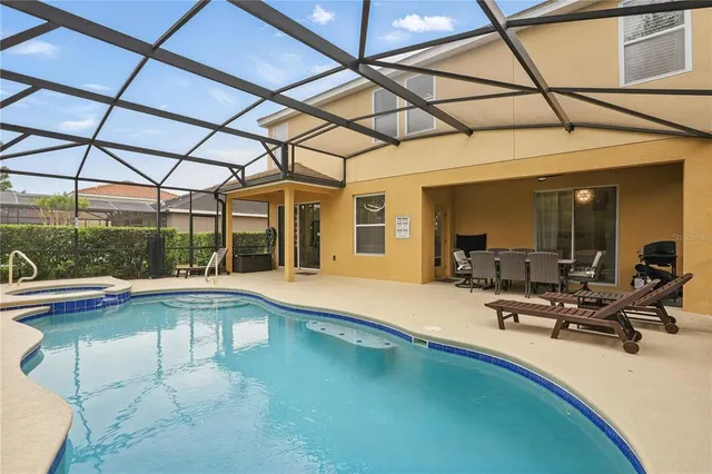 an aerial view of residential house with outdoor space and trees all around