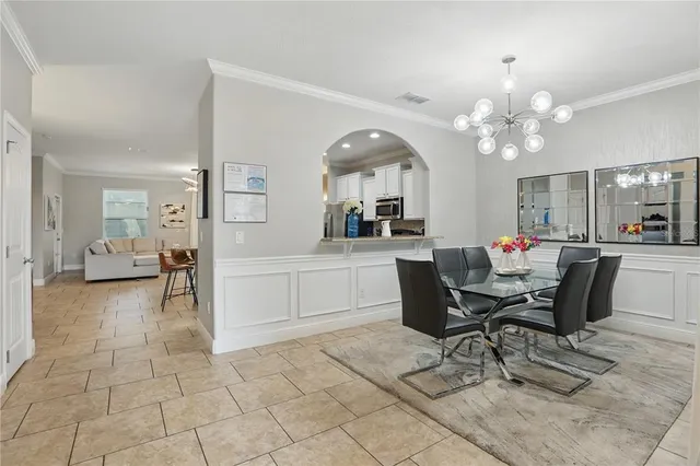 a view of a dining room with furniture and a chandelier