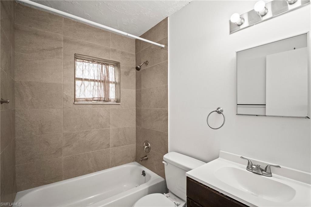 3215 Jeffcott Street Fort Myers, FL 33916 - Photo 17 of 33 Bathroom featuring vanity and tub / shower combination