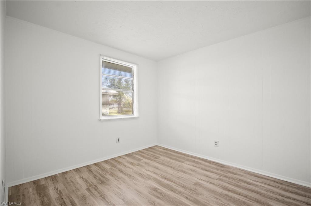 3215 Jeffcott Street Fort Myers, FL 33916 - Photo 20 of 33 Unfurnished room with wood finished floors and baseboards