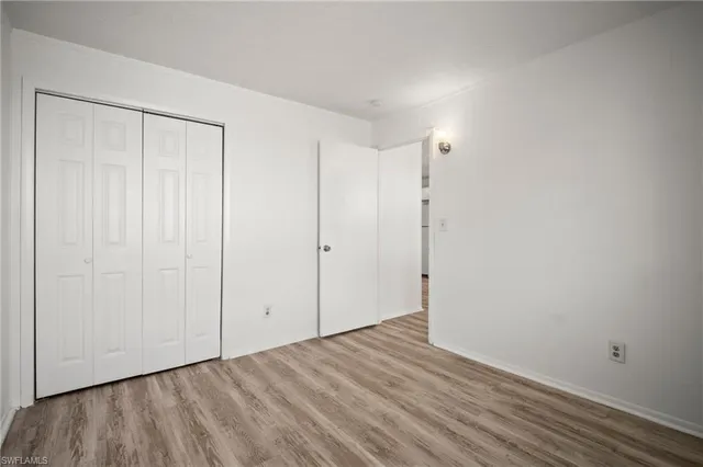 a view of a kitchen with wooden floor and a sink