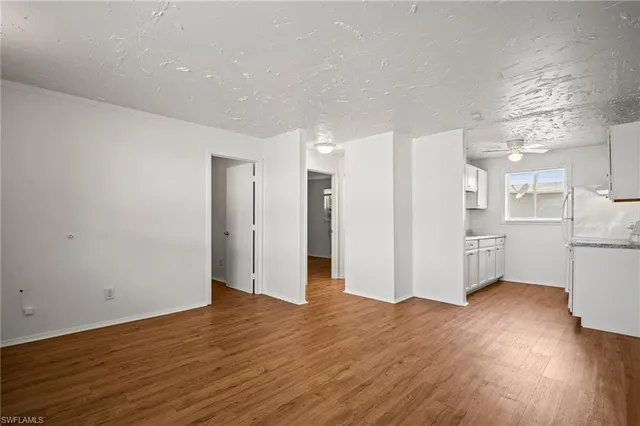 a view of empty room with wooden floor