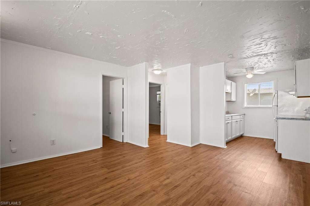 3215 Jeffcott Street Fort Myers, FL 33916 - Photo 22 of 33 Unfurnished living room with light wood-style floors and ceiling fan