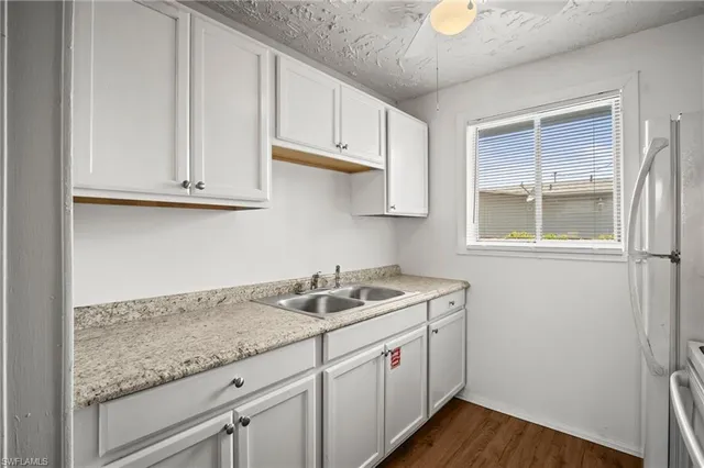 a kitchen with stainless steel appliances granite countertop a refrigerator and a stove