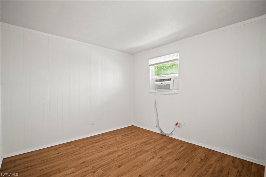 3215 Jeffcott Street Fort Myers, FL 33916 - Photo 28 of 33 Unfurnished room featuring wood finished floors and cooling unit
