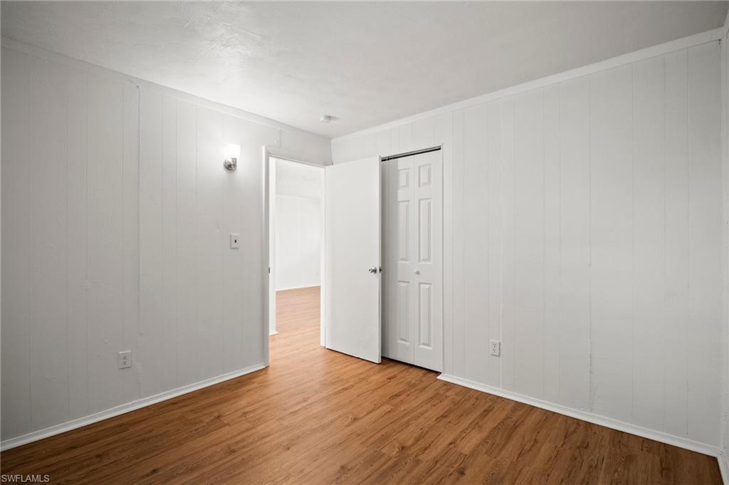 3215 Jeffcott Street Fort Myers, FL 33916 - Photo 29 of 33 Unfurnished room featuring wood finished floors and baseboards