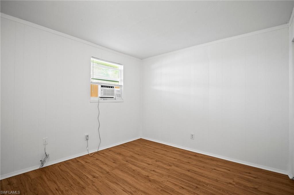 3215 Jeffcott Street Fort Myers, FL 33916 - Photo 30 of 33 Empty room featuring wood finished floors and cooling unit