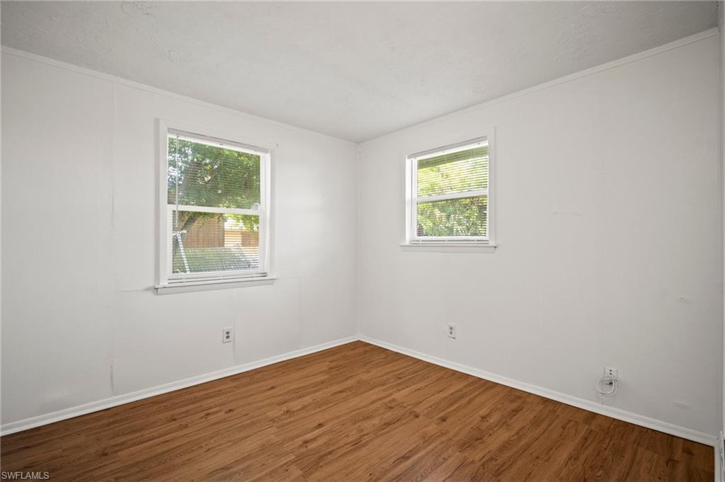 3215 Jeffcott Street Fort Myers, FL 33916 - Photo 7 of 33 Spare room featuring wood finished floors and healthy amount of natural light
