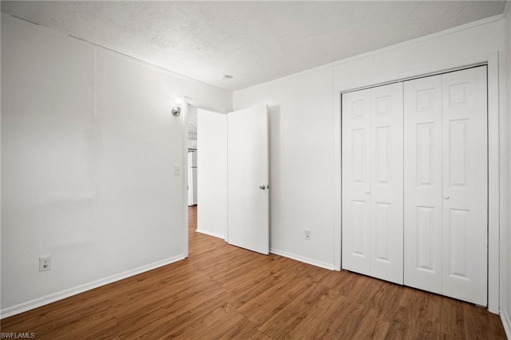 3215 Jeffcott Street Fort Myers, FL 33916 - Photo 8 of 33 Unfurnished bedroom featuring wood finished floors and a closet