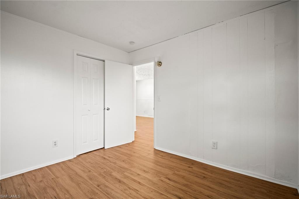 3215 Jeffcott Street Fort Myers, FL 33916 - Photo 10 of 33 Unfurnished room featuring wood finished floors and baseboards