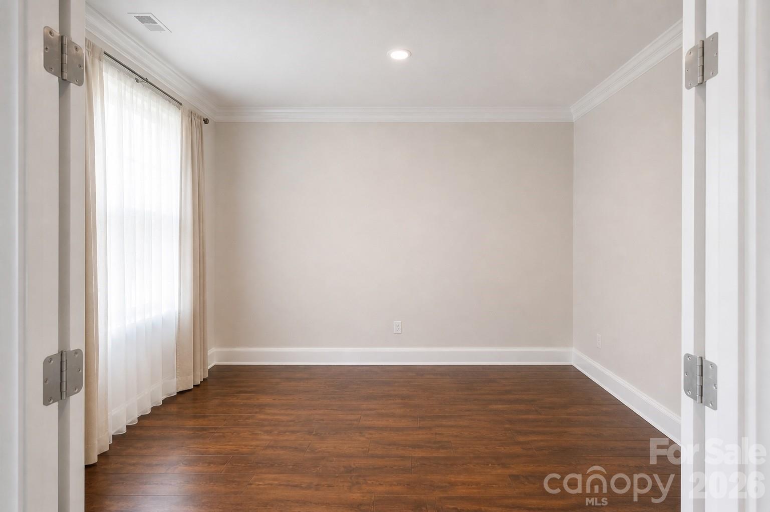 8119 Warford Little Road Denver, NC 28037 - Photo 12 of 43 a view of an empty room with wooden floor and a window