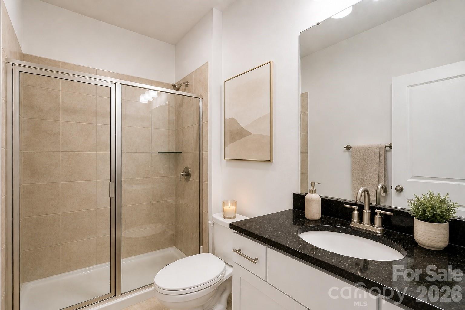 8119 Warford Little Road Denver, NC 28037 - Photo 23 of 43 a bathroom with a granite countertop sink toilet a mirror and shower
