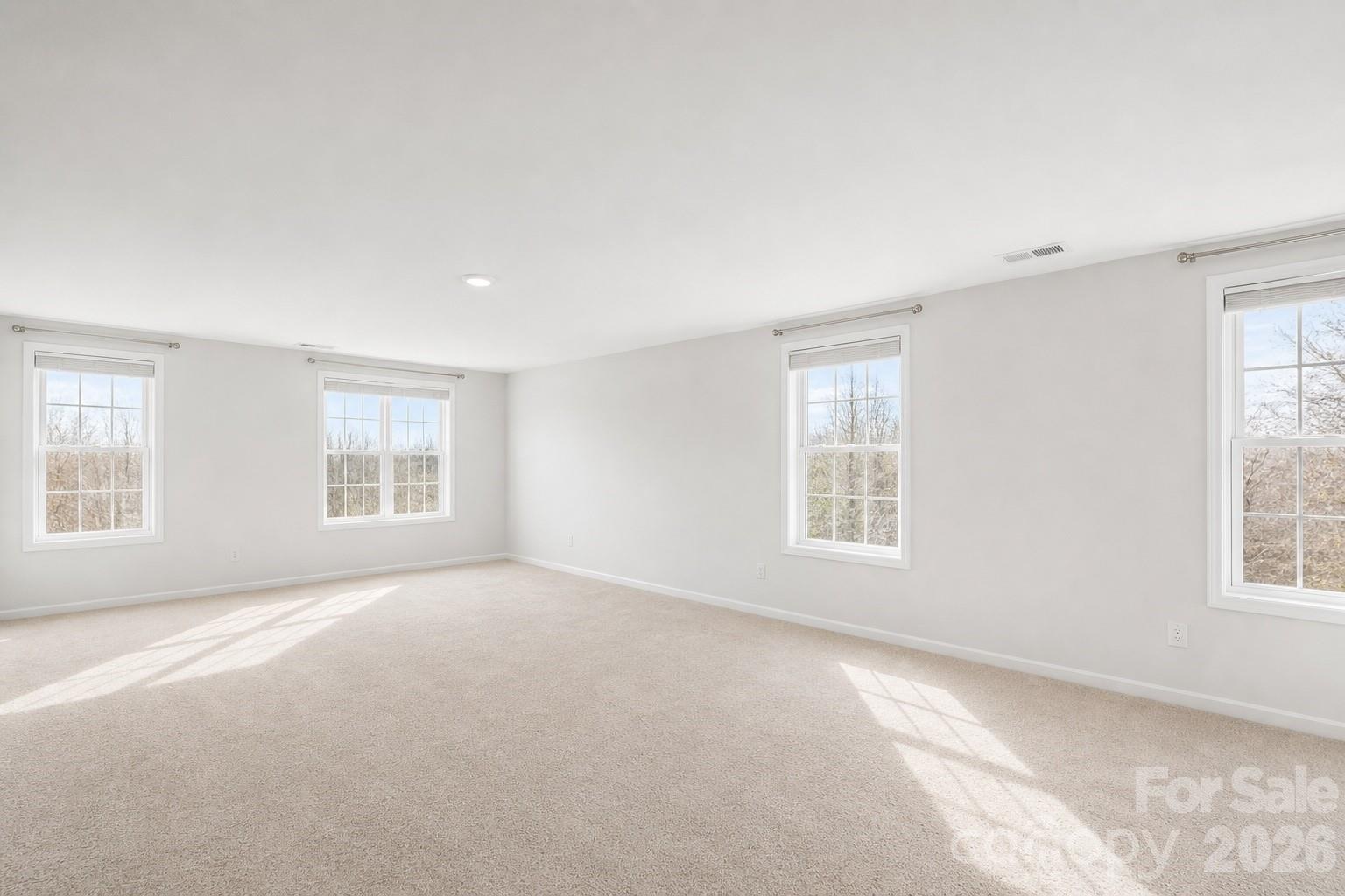 8119 Warford Little Road Denver, NC 28037 - Photo 32 of 43 a view of a big room with windows and chandelier fan