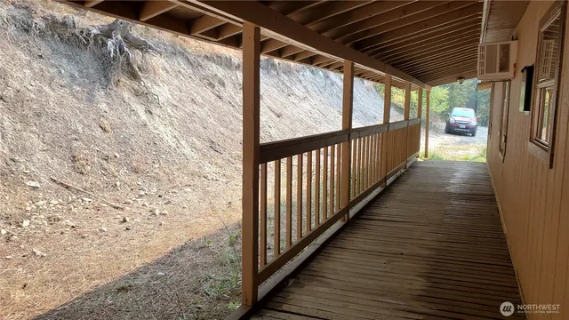 a view of a porch with wooden floor and stairs