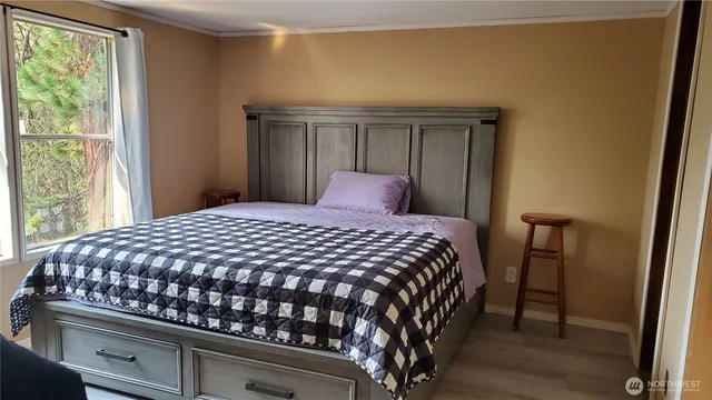 a bedroom with a bed and a window