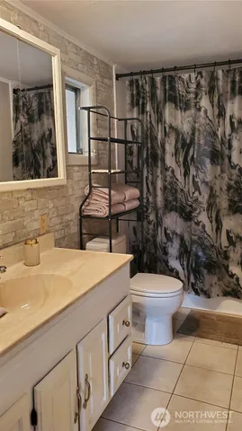 a bathroom with a sink toilet and window