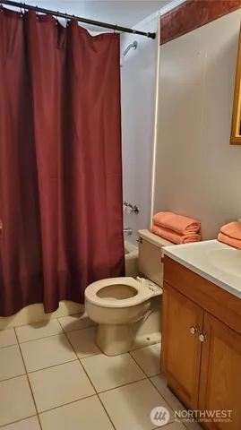 a white toilet sitting next to a shower curtain