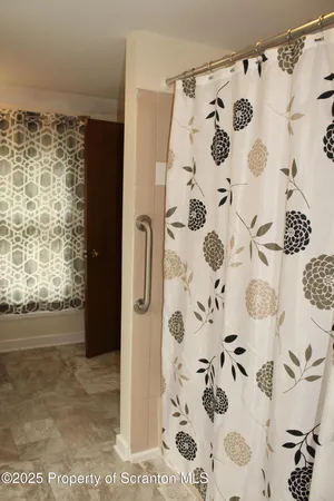 a view of bathroom with a shower curtain